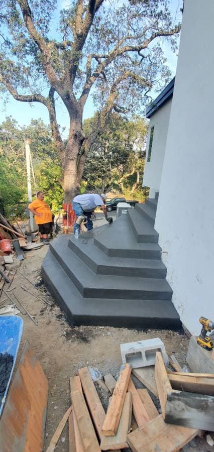 picture of a newly remodeled concrete stairway and staircase in the backyard of a home